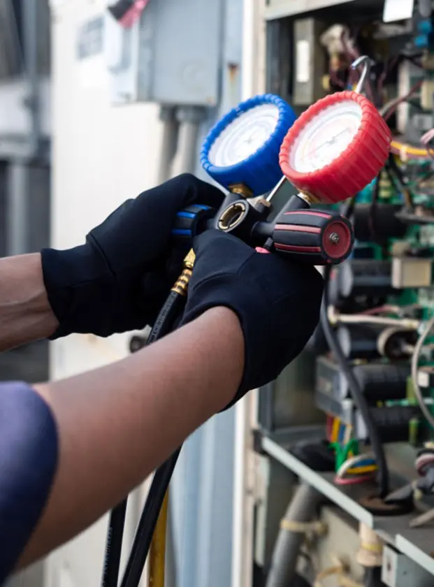 AC Technician working on air conditioning unit